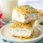 two peppermint crunch cake slices stacked on a small plate.
