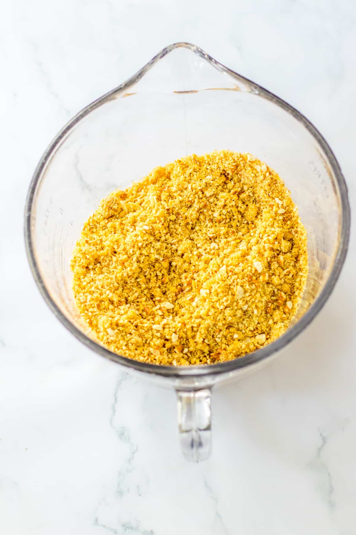 cookie and pretzel crumbs in a measuring cup.