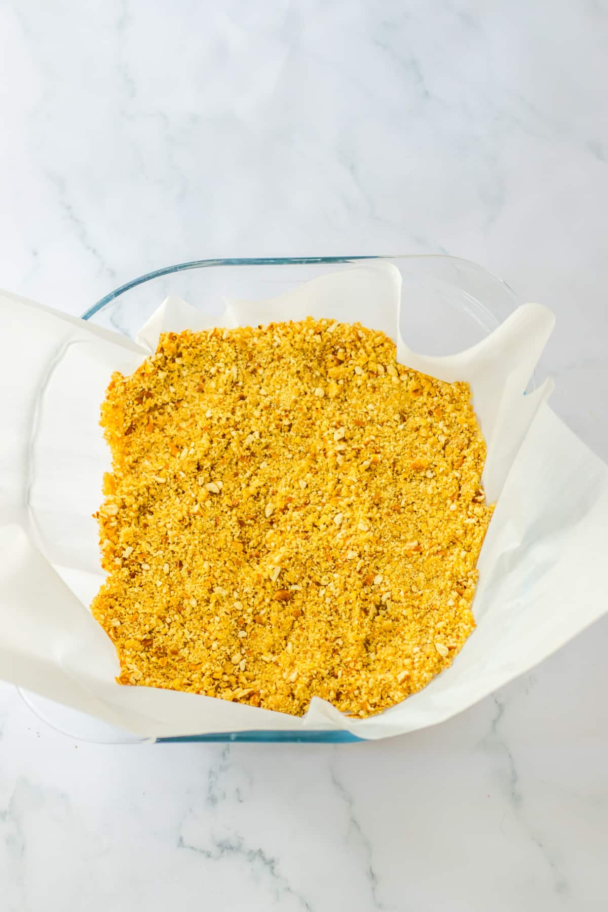 cookie crust pressed into a parchment lined baking dish.