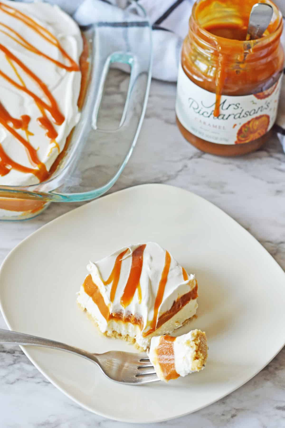 slice of pumpkin lasagna on a plate with a bite on a fork.