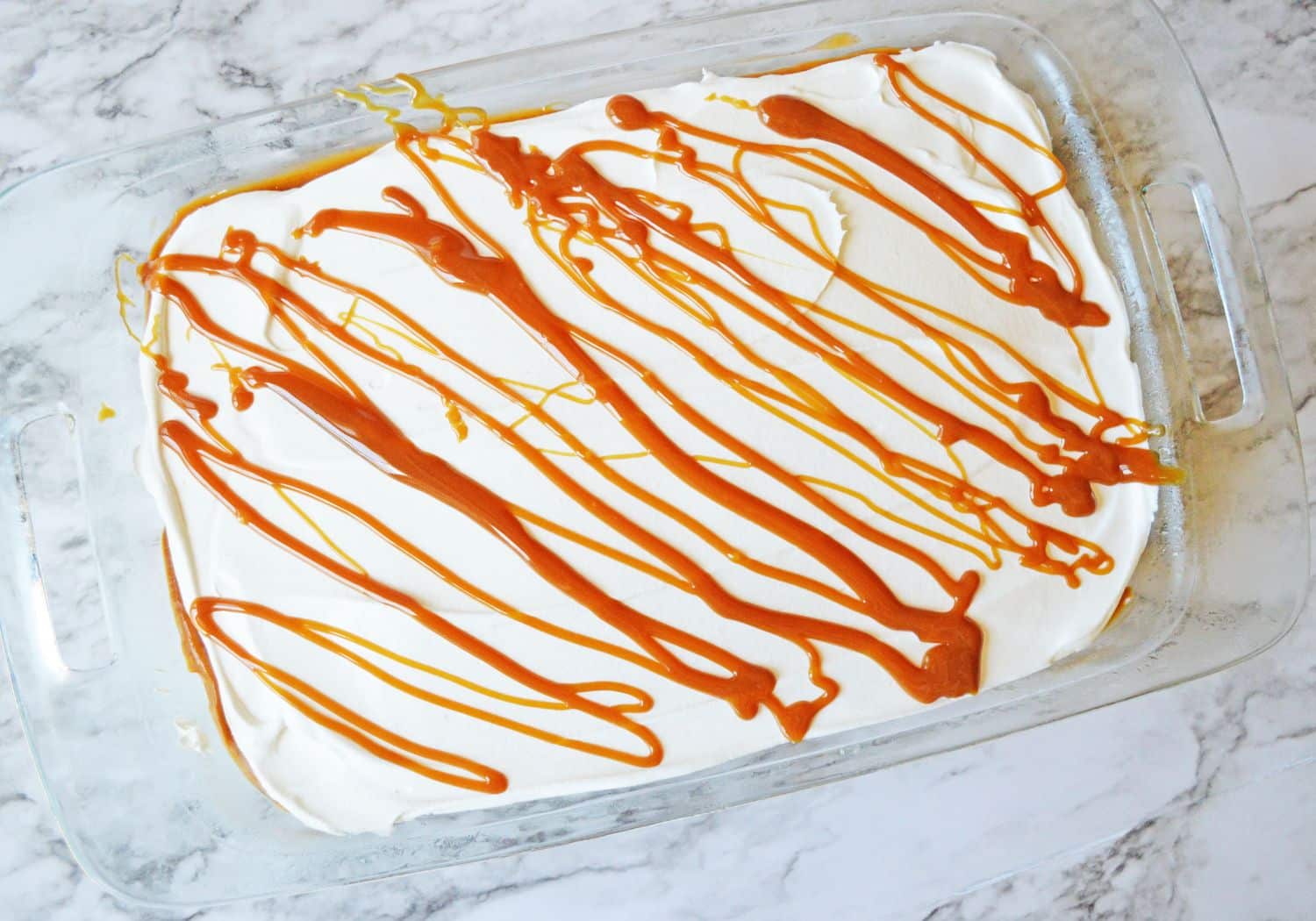 uncut pumpkin lasagna in a glass baking dish.