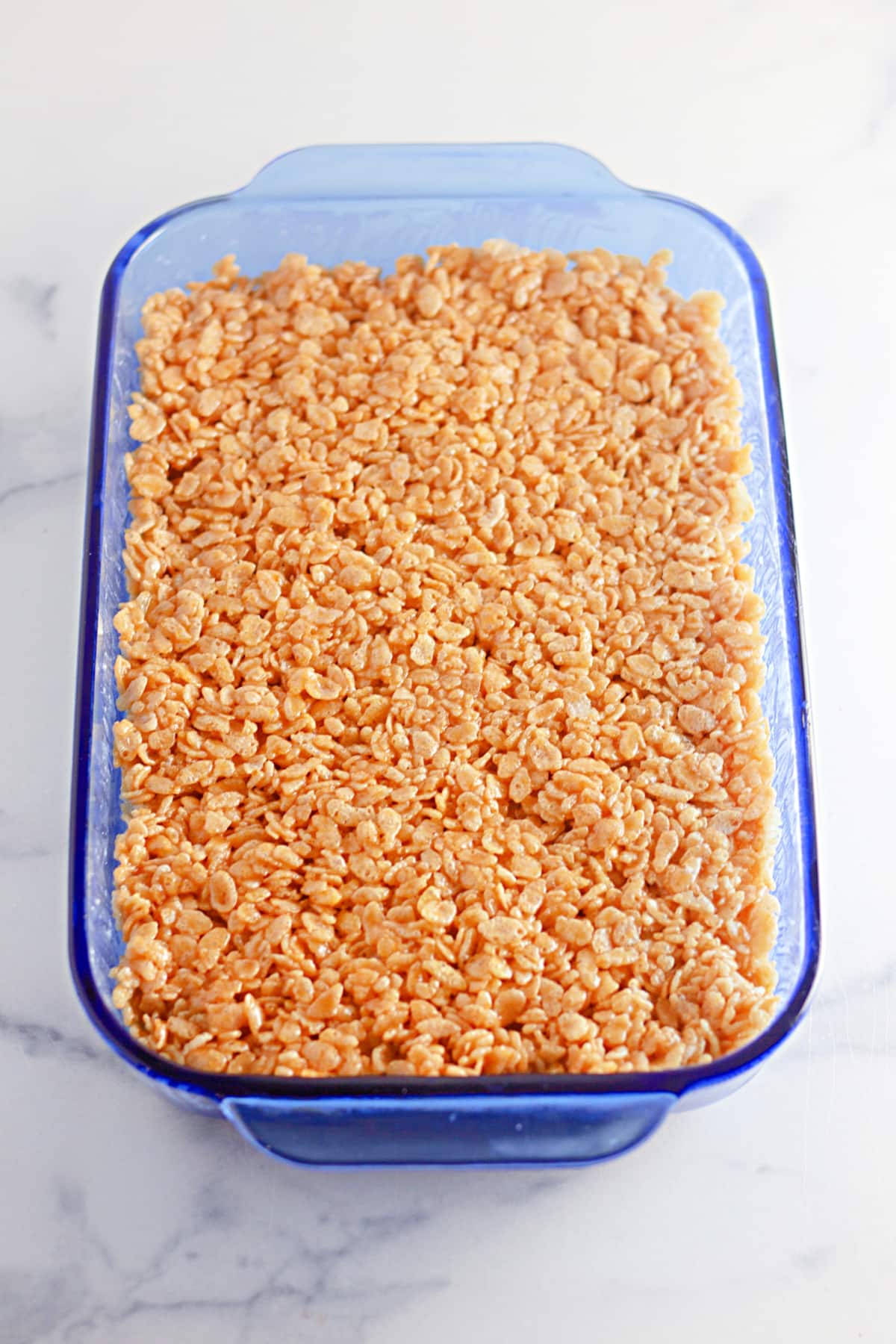 pumpkin rice krispies treats pressed into a baking dish.