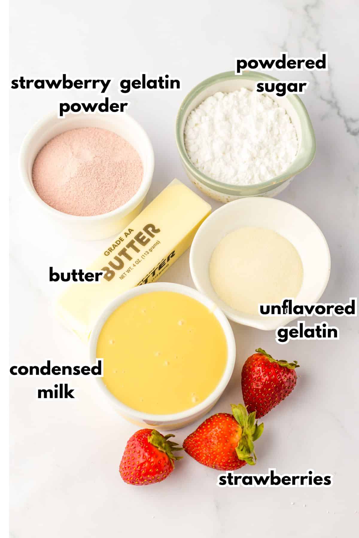 bowls of strawberry gelatin powder, powdered sugar, butter, condensed milk, unflavored gelatin, and strawberries.