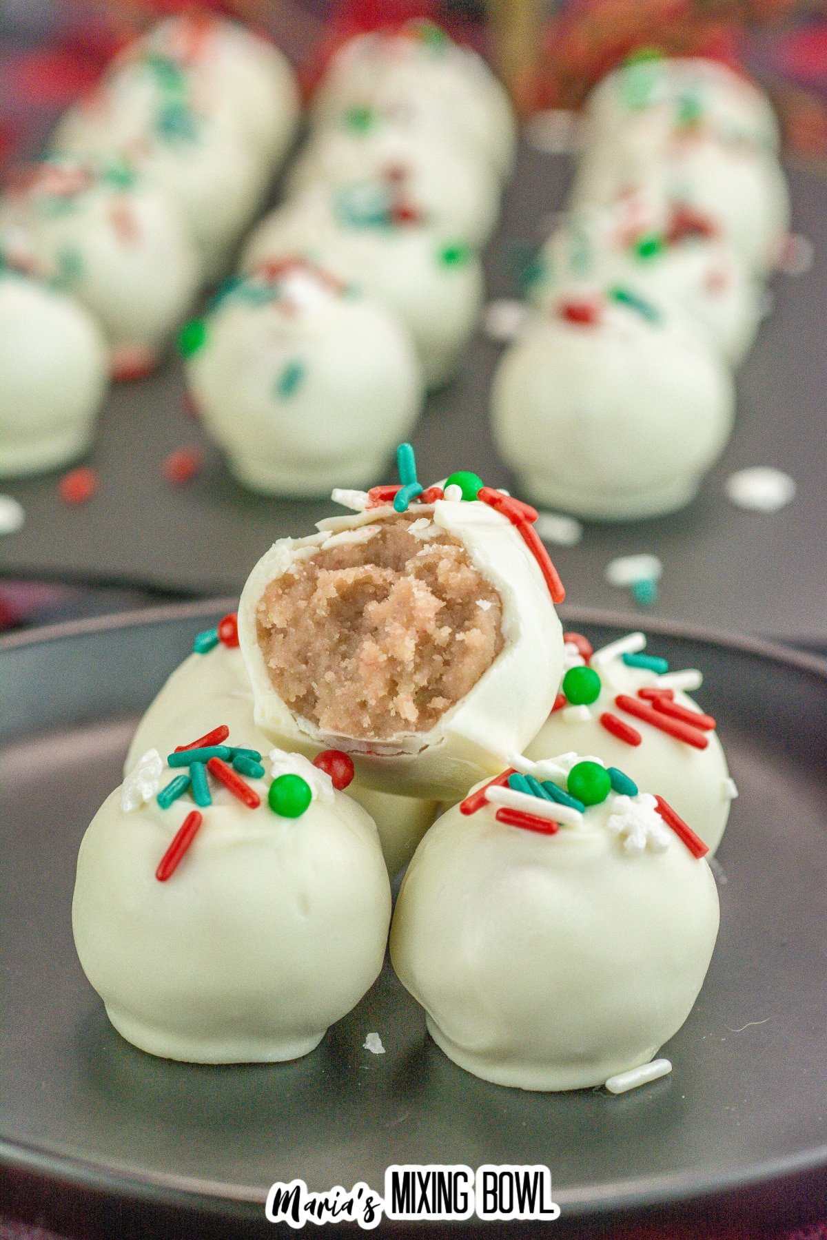 five sugar cookie truffles stacked with a bite missing from the top one.