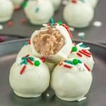 five sugar cookie truffles stacked with a bite missing from the top one.