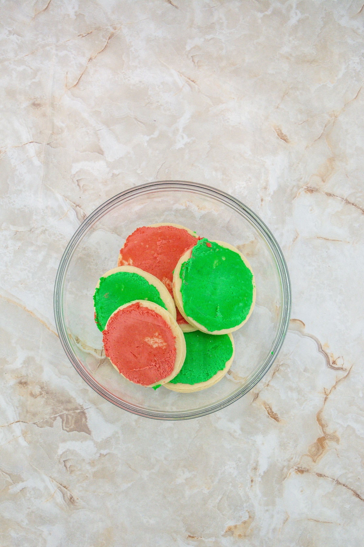 frosted sugar cookies in a glass bowl ready to crumble.