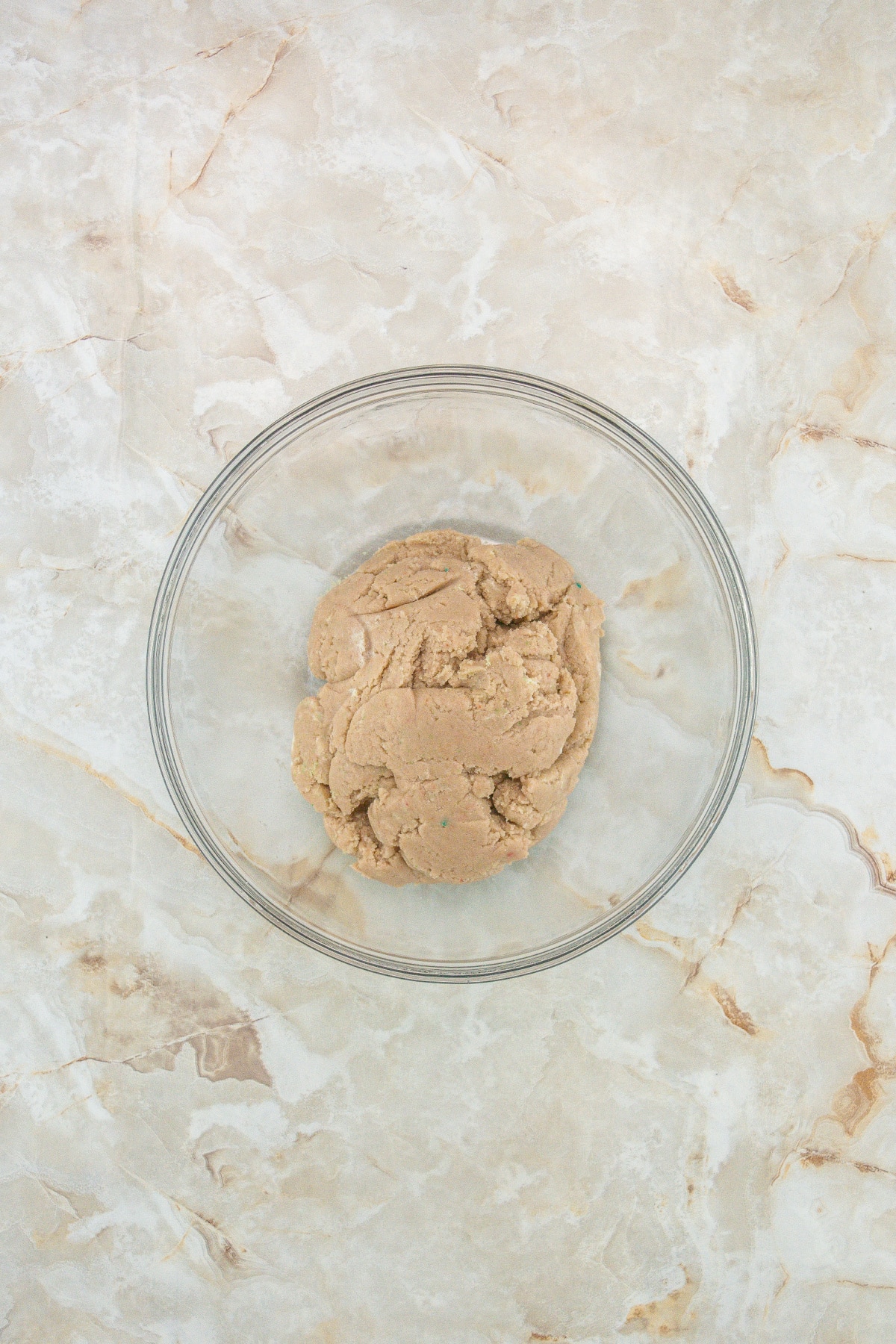 truffle dough in a glass mixing bowl ready to be shaped.