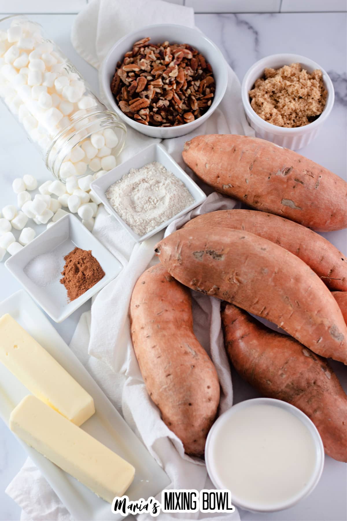 bowls of pecans, brown sugar, cinnamon, salt, marshmallows, sweet potatoes, and butter.