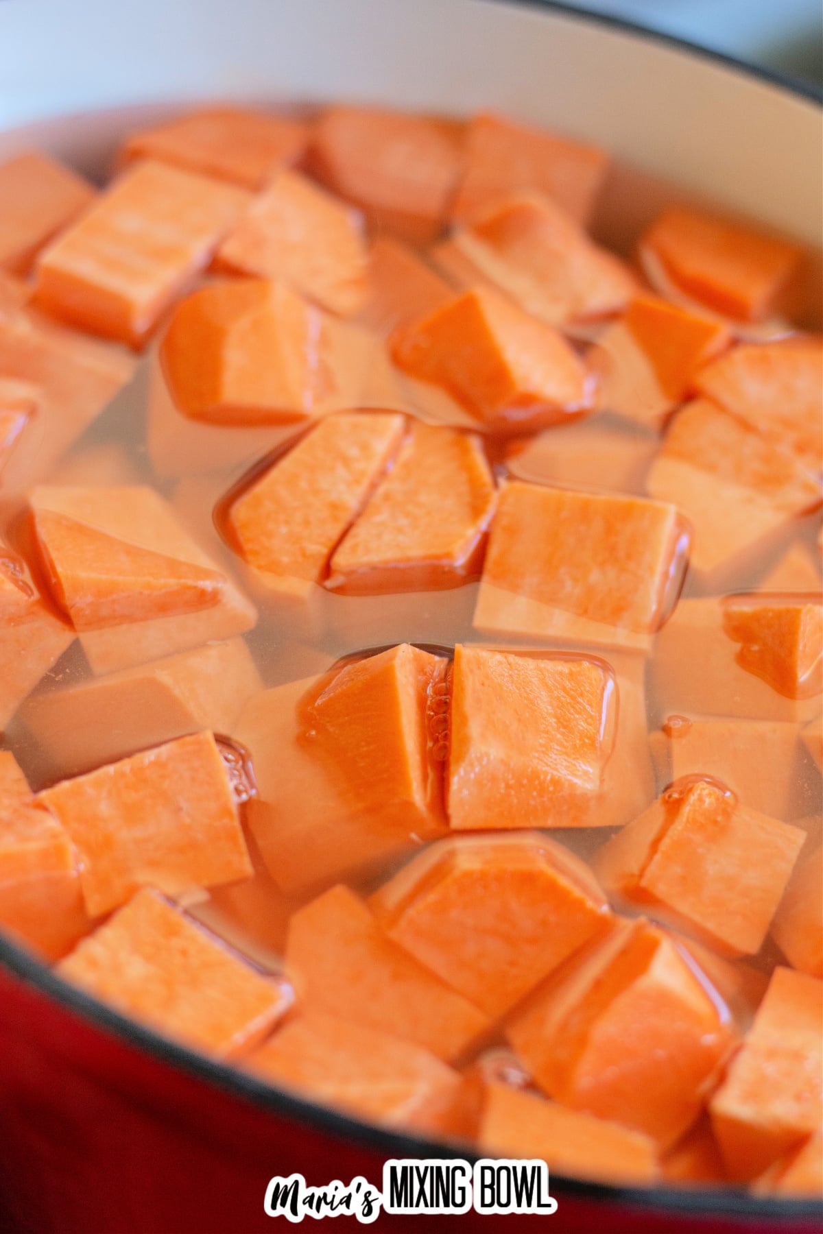diced sweet potato cubes boiling in a large pot.