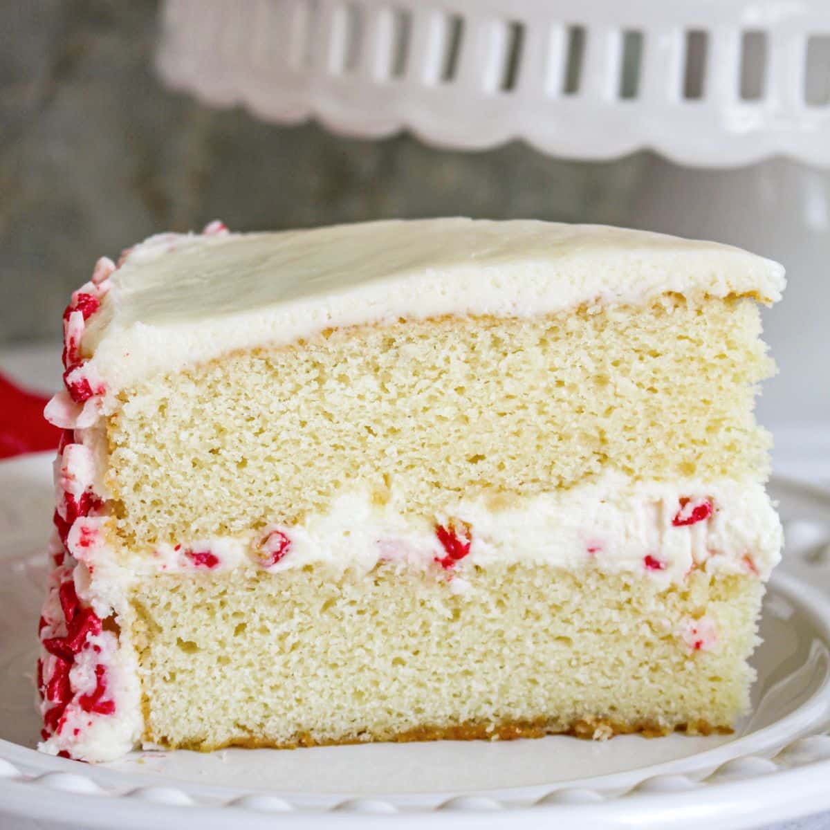 slice of white chocolate peppermint cake on a plate.