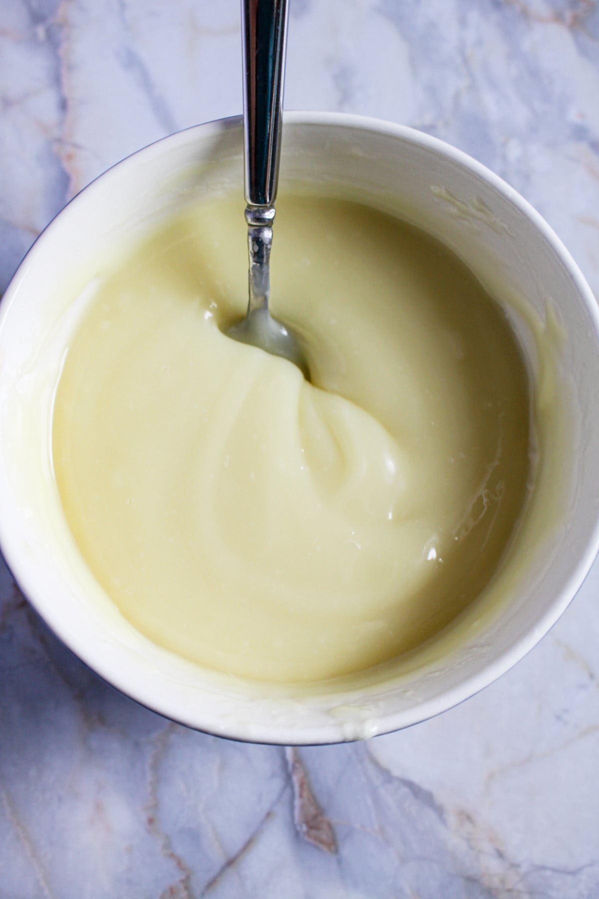 white chocolate being melted in a small bowl.