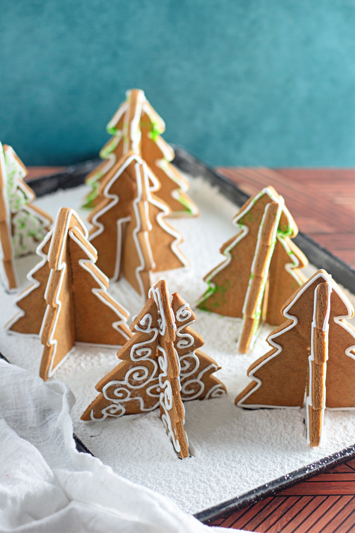 3d gingerbread trees on a baking sheet.