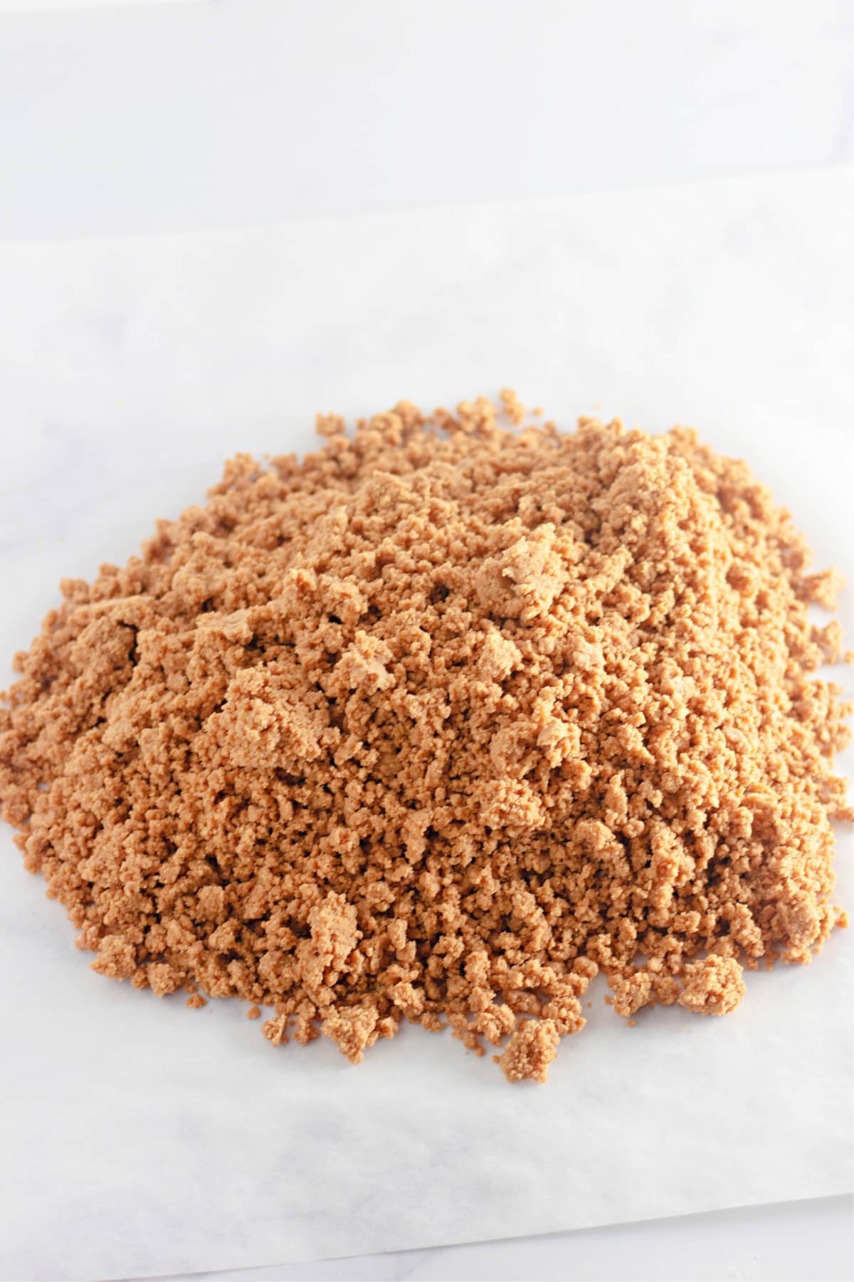 mound of crumbly gingerbread tree dough on a counter.