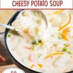 bowl filled with cheesy potato soup and topped with shredded cheese and sliced green onions.
