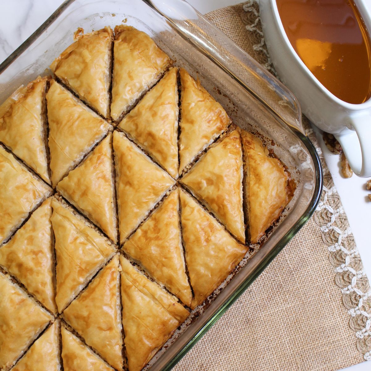 baked baklava in a glass baking dish.