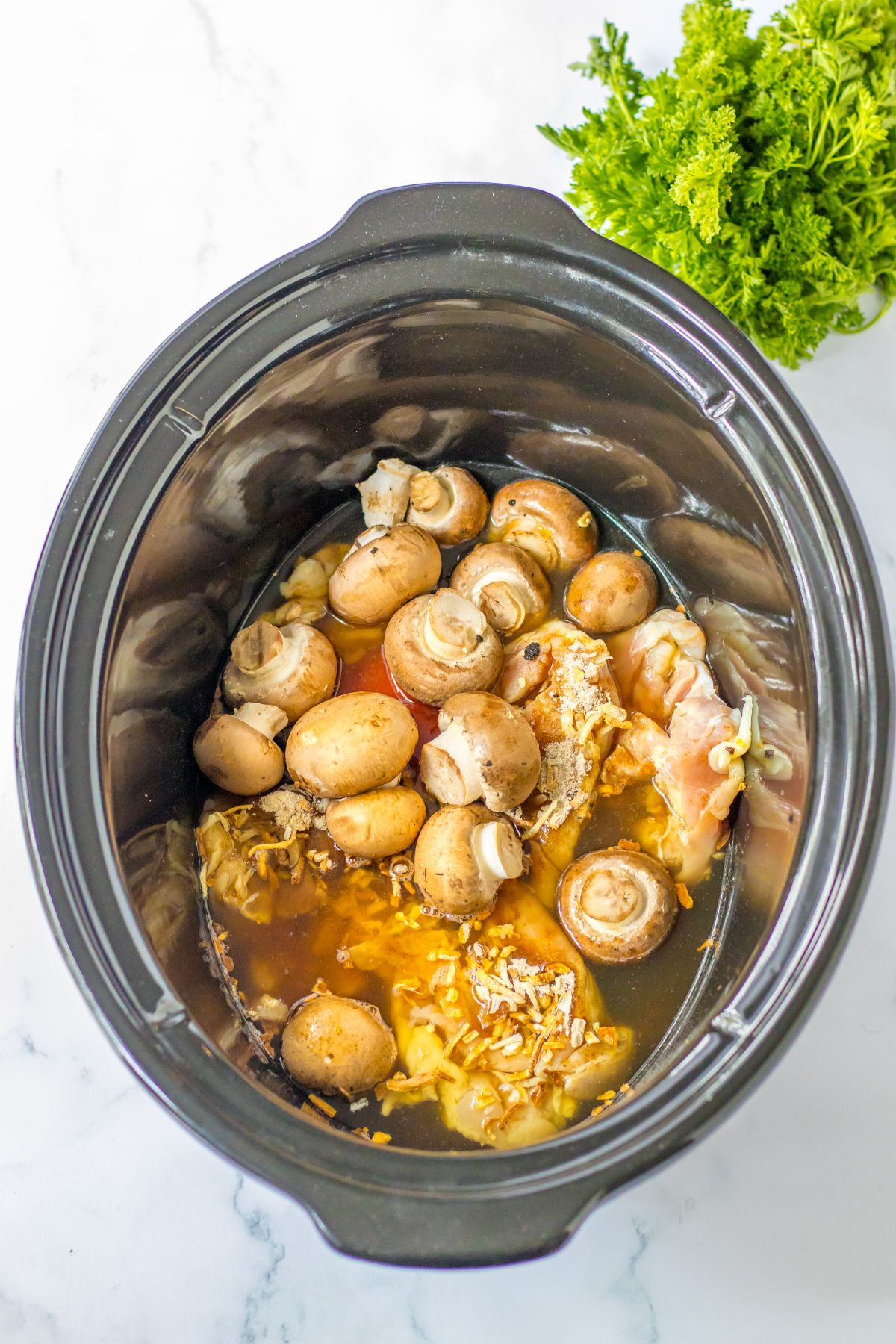 mushrooms, chicken, broth, and seasonings in a slow cooker.