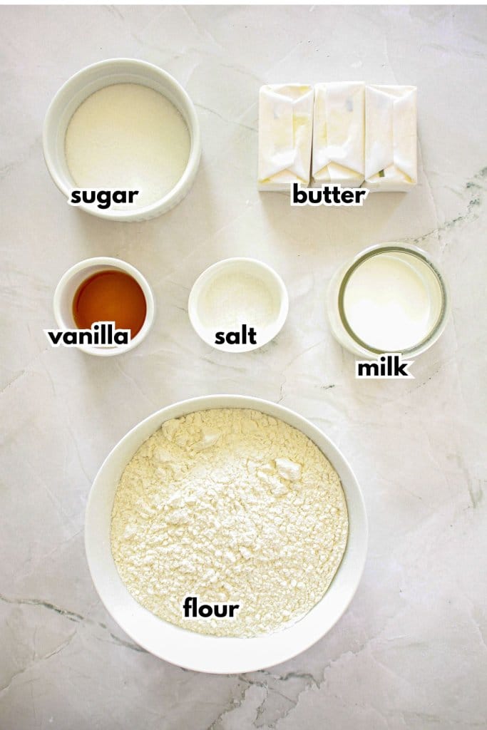 bowls of sugar, butter, vanilla, salt, milk, and flour.