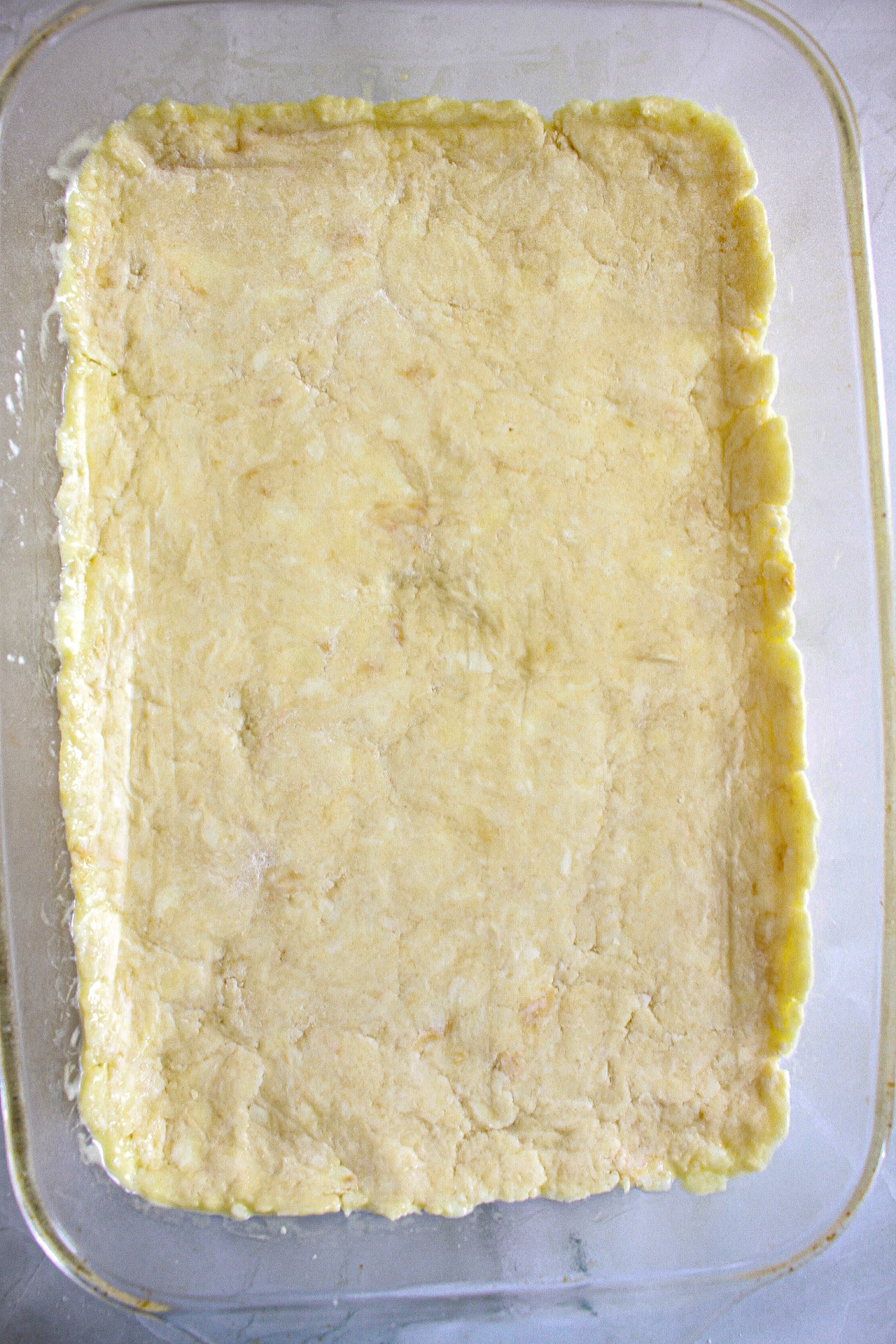 homemade crust pressed into a 9x13 glass baking dish.