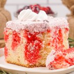 slice of cranberry poke cake on a small plate.