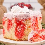 Cranberry Poke Cake slice of cranberry poke cake on a small plate.
