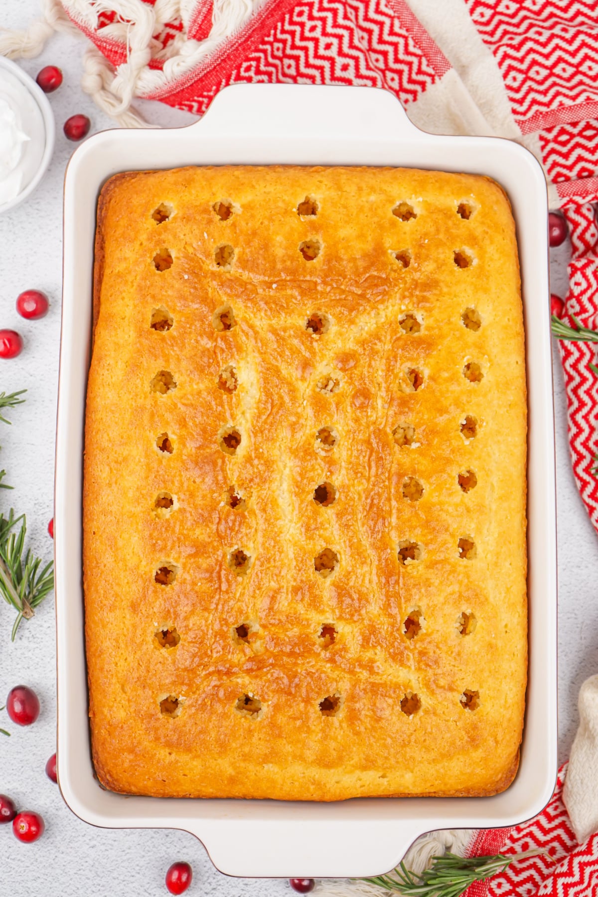 holes being poked into a baked cake.