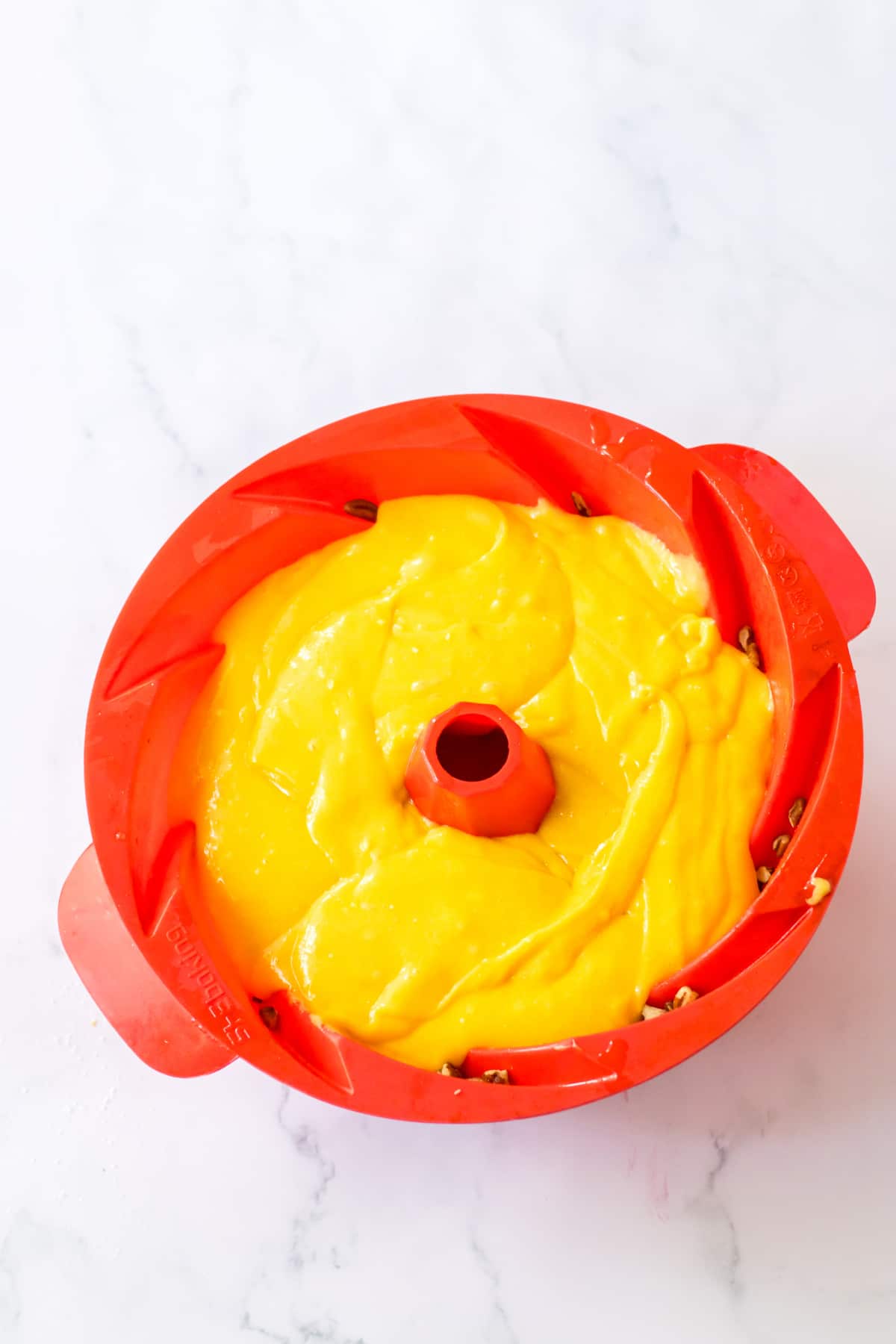 cake batter in a silicone bundt pan ready for the oven.