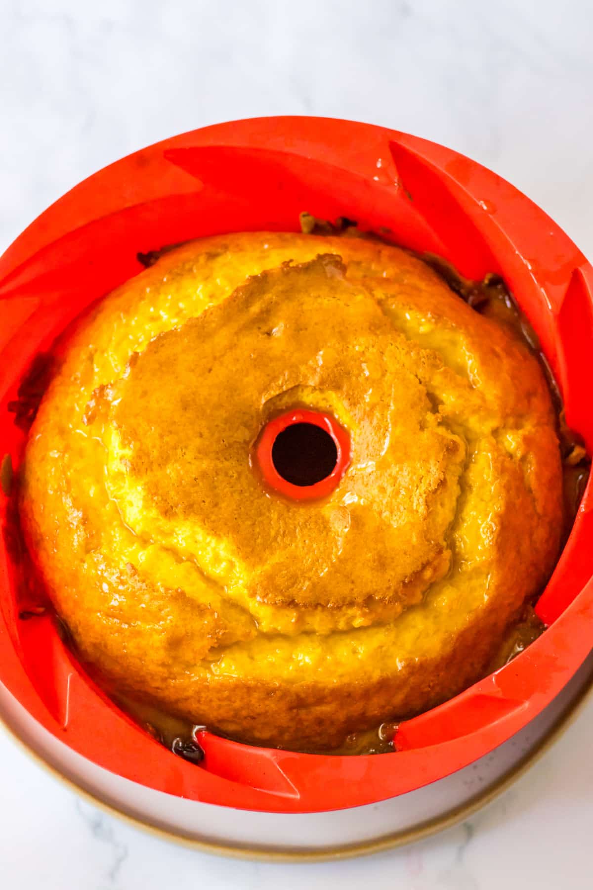 baked rum cake in a silicone bundt pan.