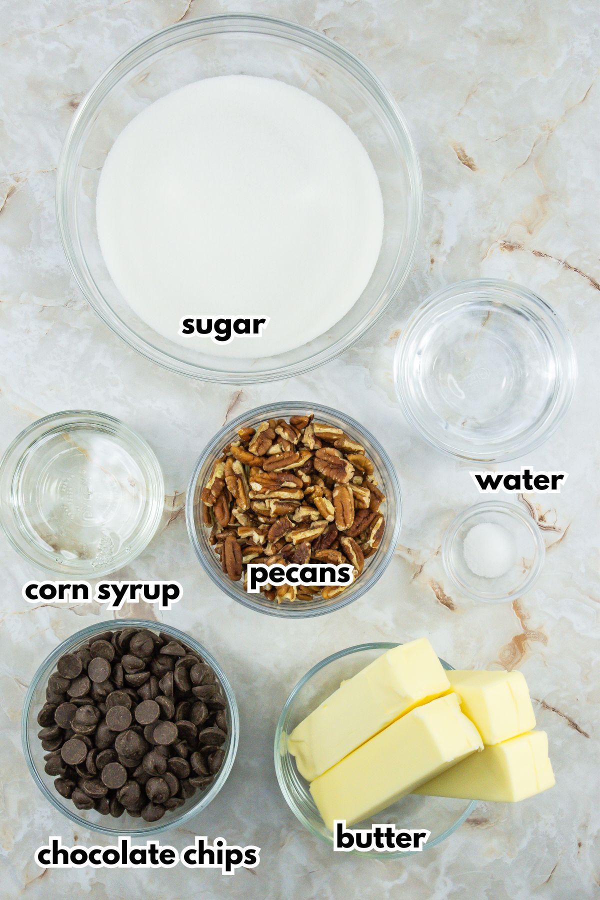 bowls of sugar, corn syrup, pecans, water, chocolate chips, and butter.