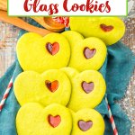 stained glass cookies on a baking tray covered with a kitchen towels.