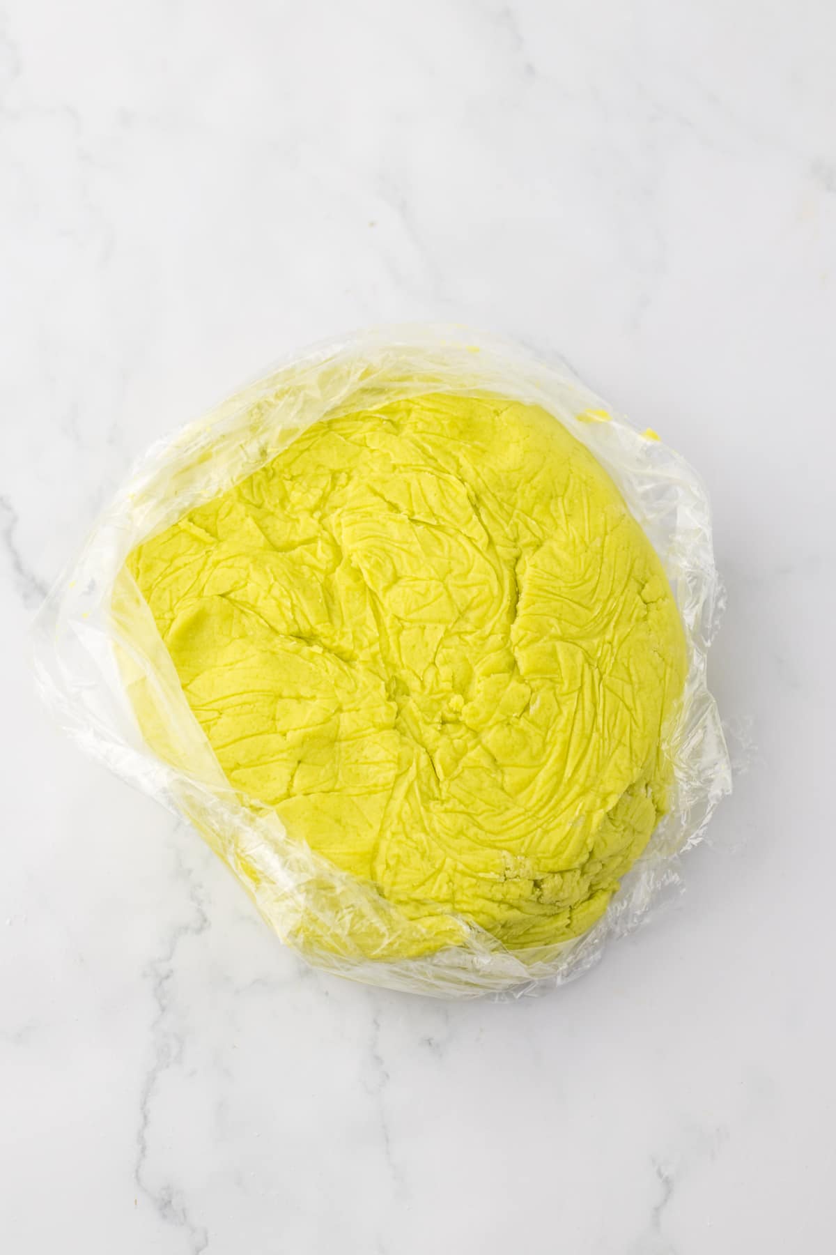 cookie dough shaped into a block and wrapped in a plastic wrap.