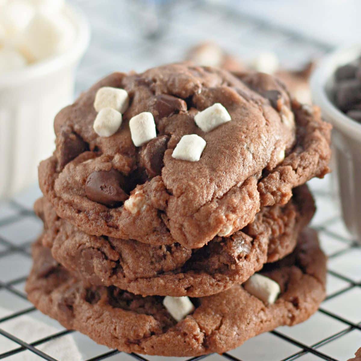 stack of three hot cocoa cookies with mini marshmallows.