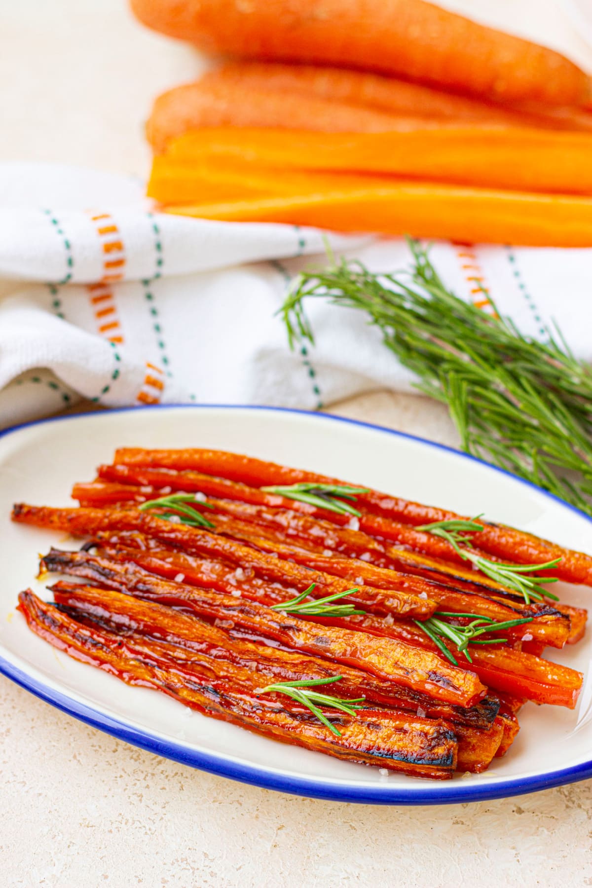 maple glazed roasted carrots garnished with parsley on a plate.