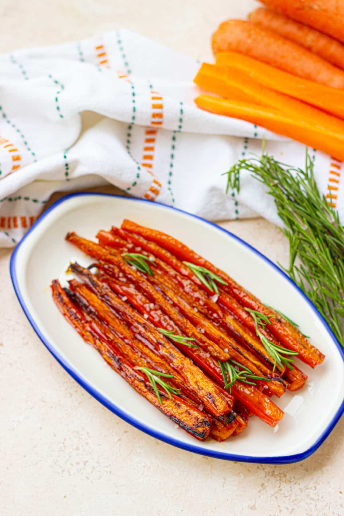maple glazed roasted carrots garnished with parsley on a plate.