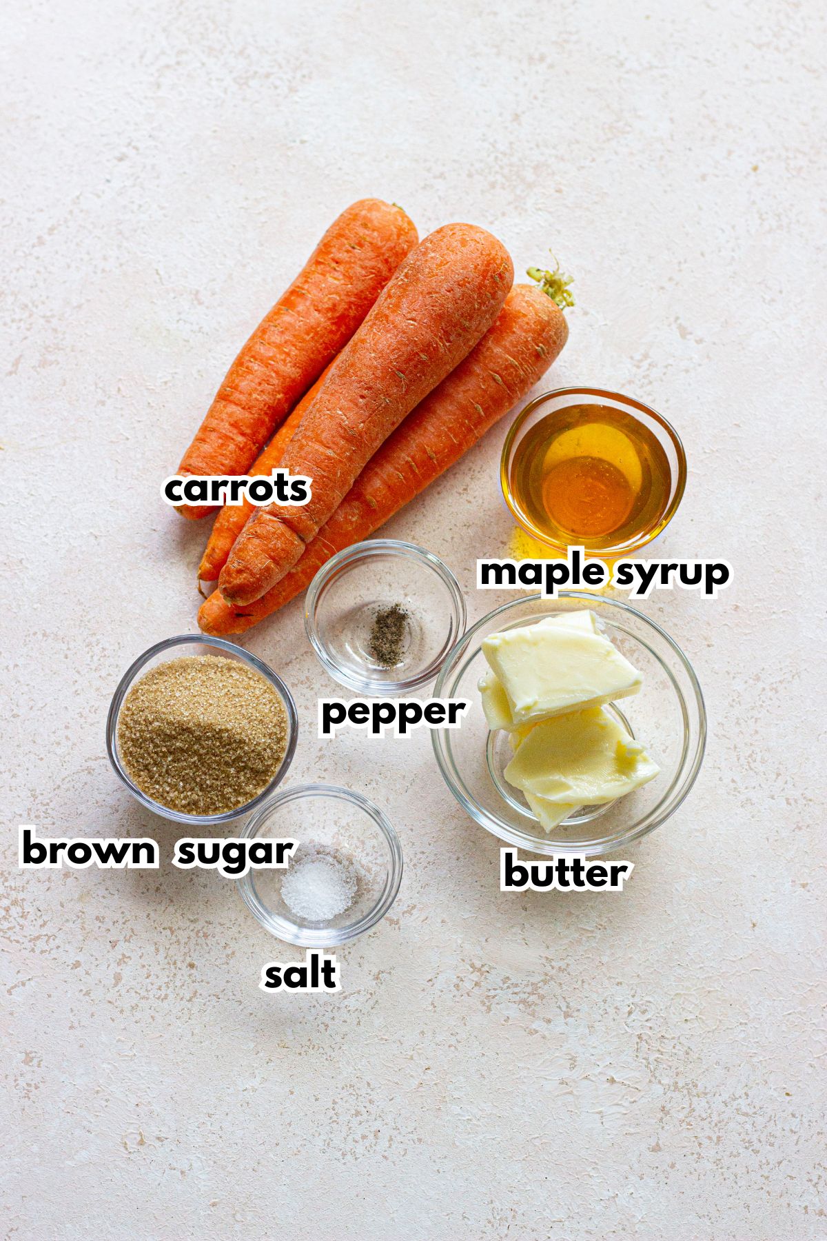 bowls of carrots, maple syrup, pepper, brown sugar, salt, and butter.
