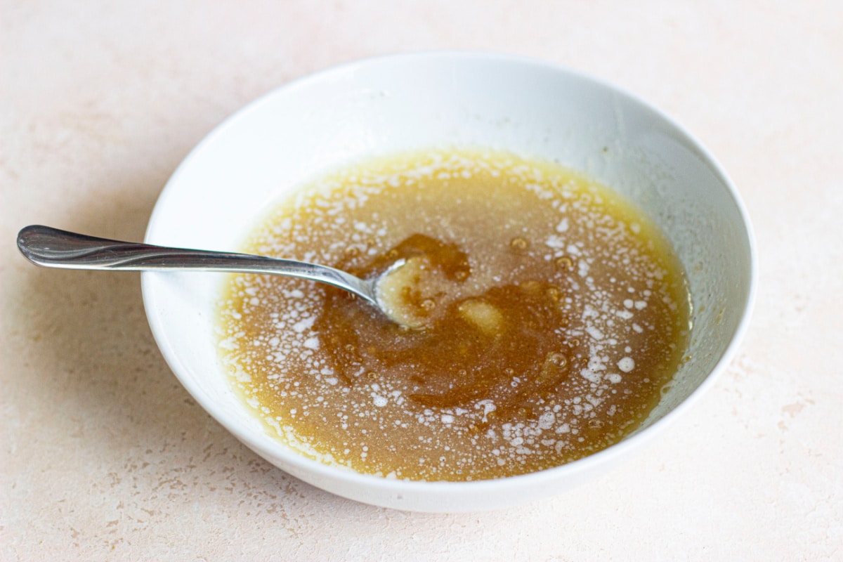 maple glaze being mixed in a small bowl.