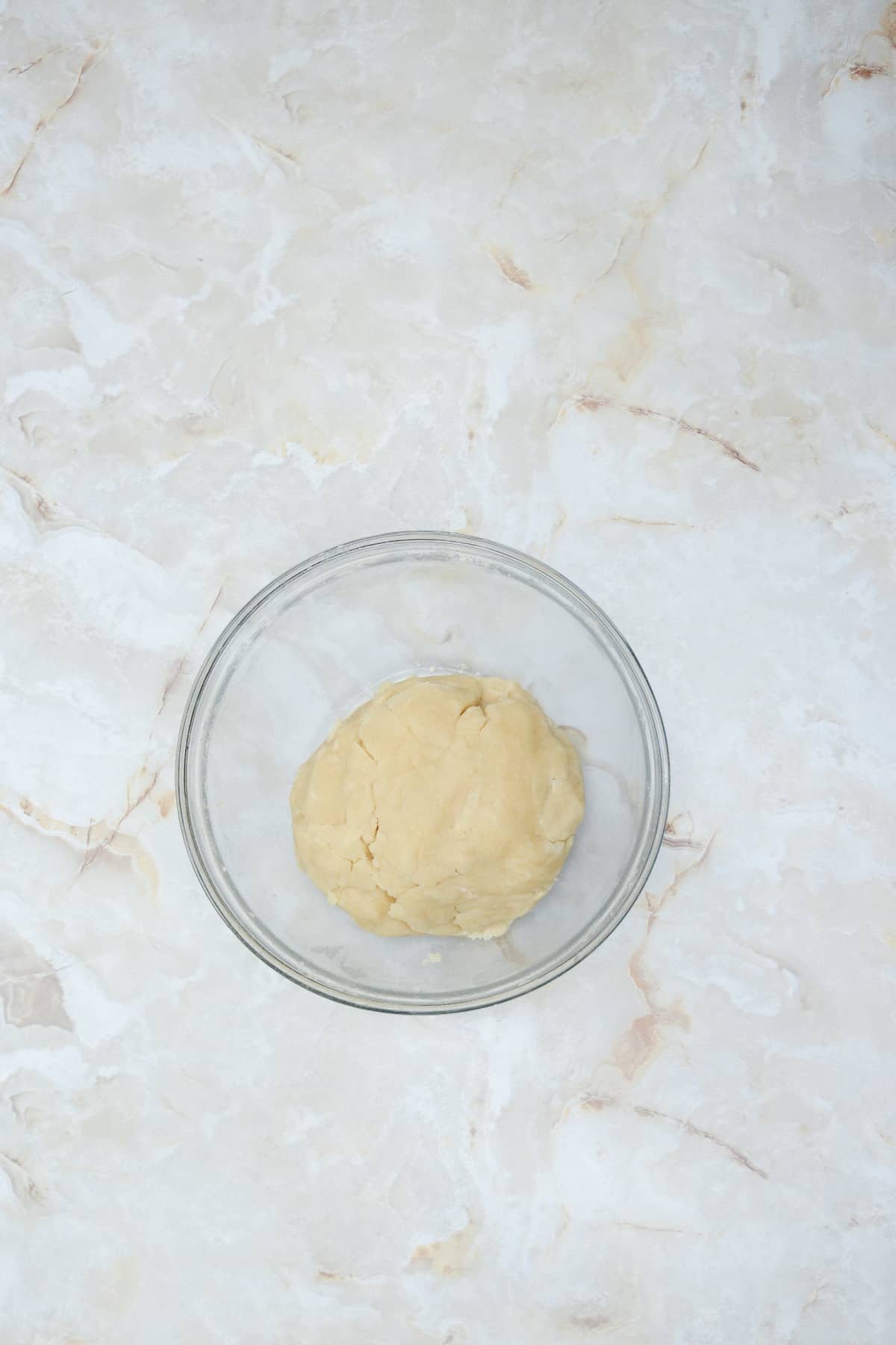 pie crust being mixed in a mixing bowl.