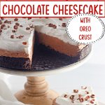 no bake chocolate cheesecake on a cake stand with a slice missing.