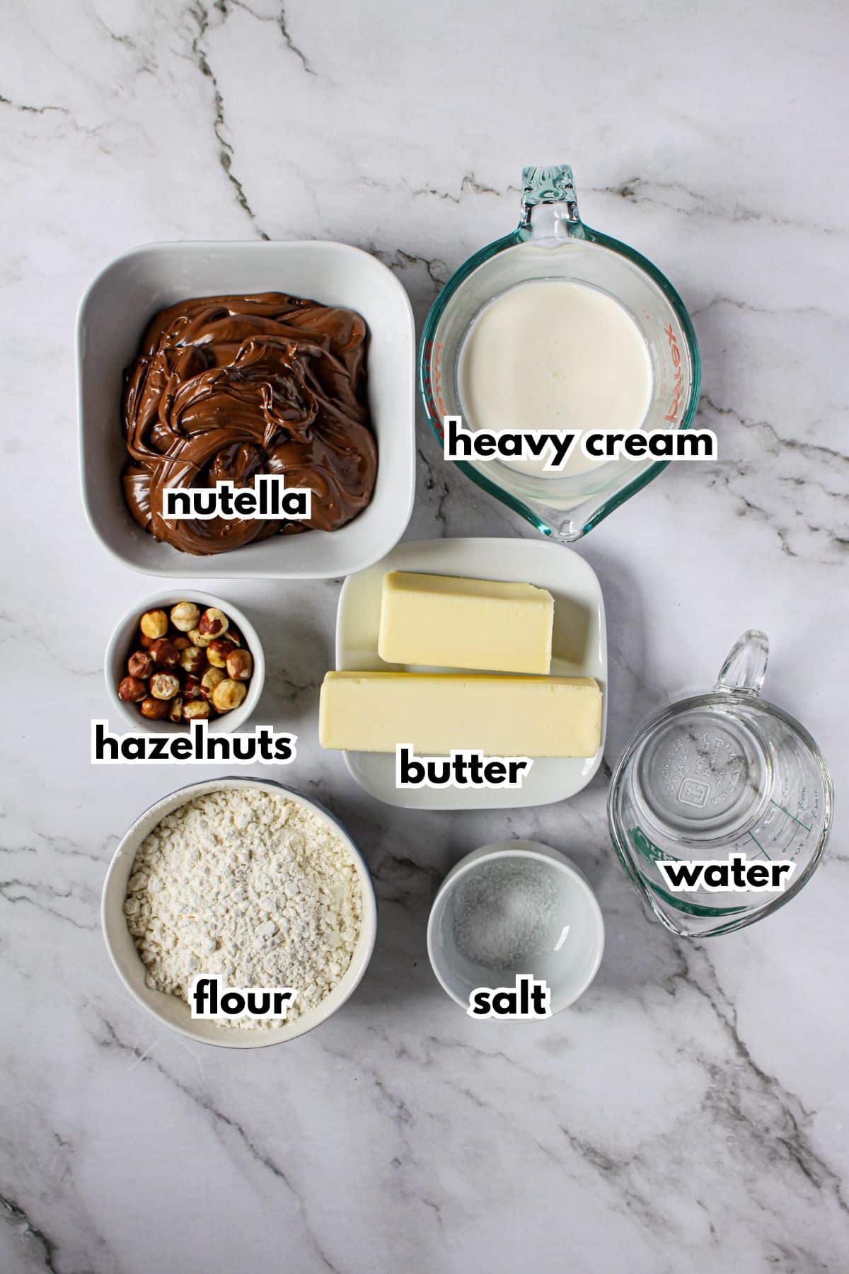 bowls of nutella, heavy cream, hazelnuts, butter, flour, salt, and water.