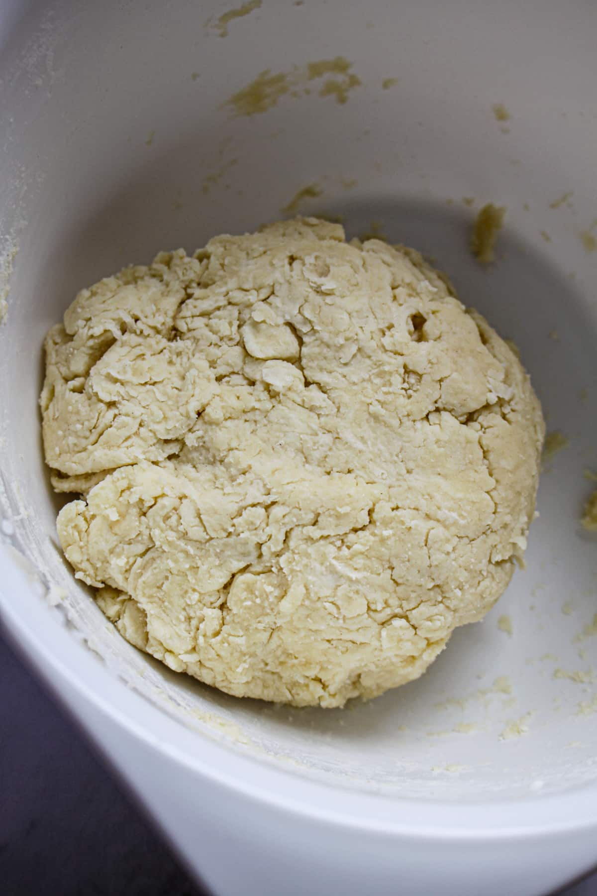 pie crust being mixed in a mixing bowl.