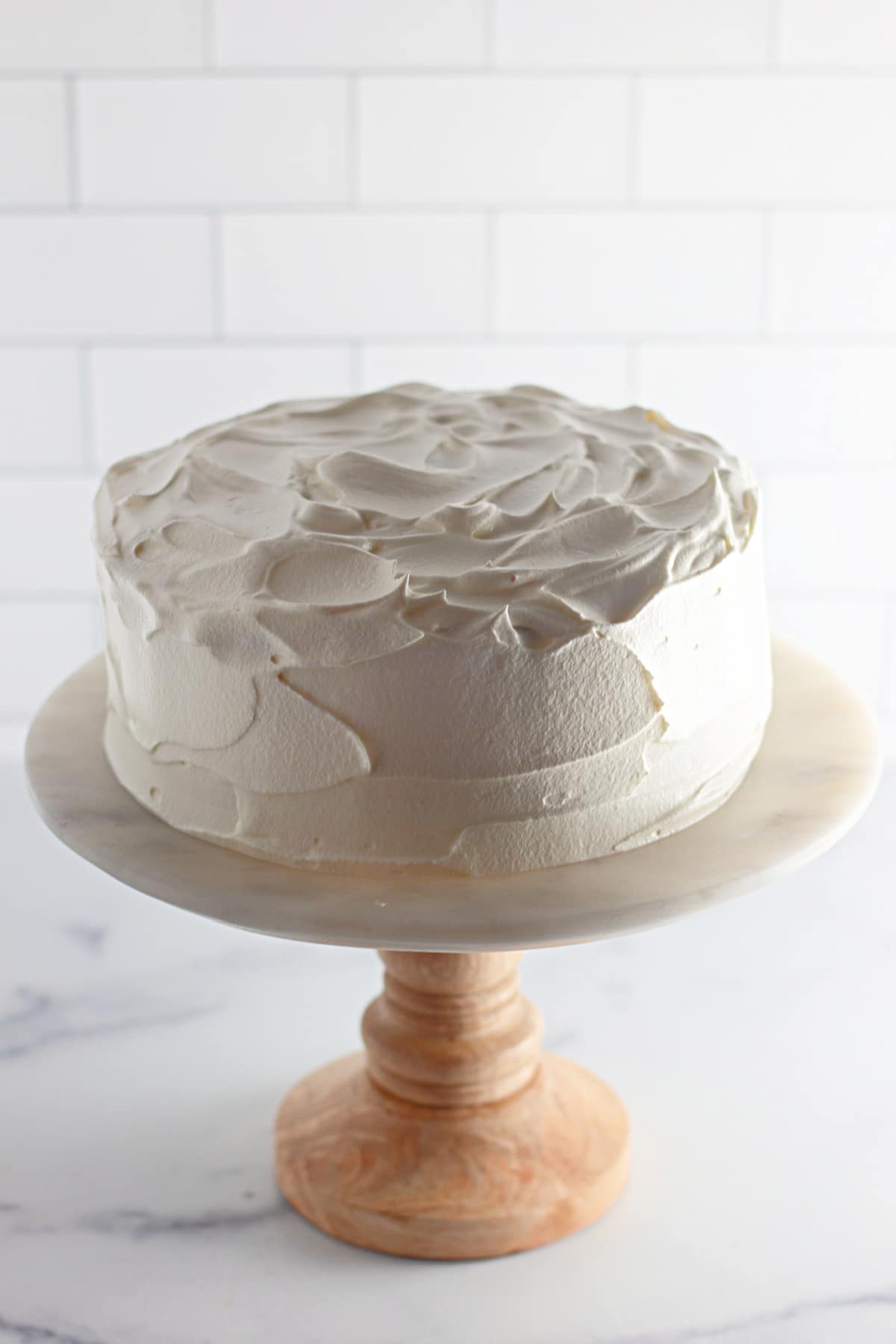 frosted cake on a cake stand.