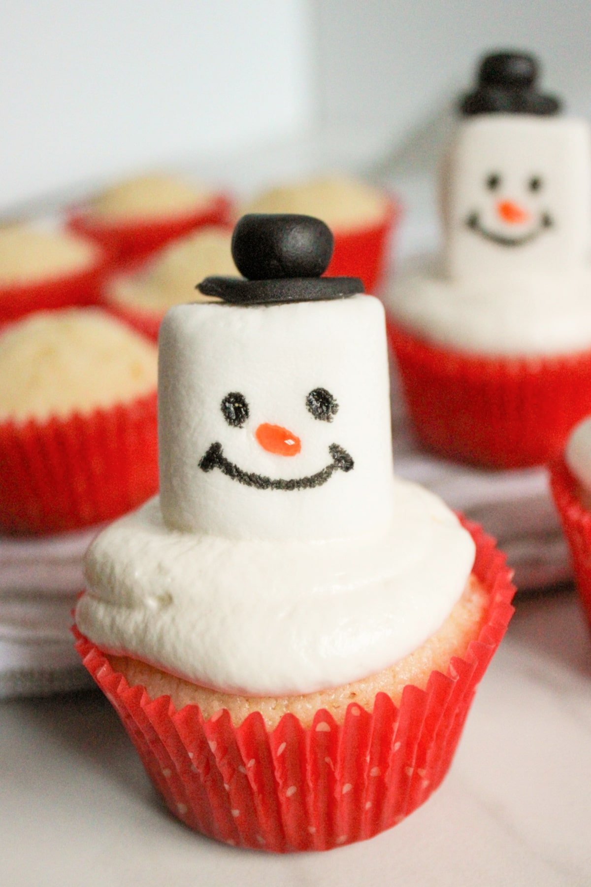 snowman cupcakes on a counter.