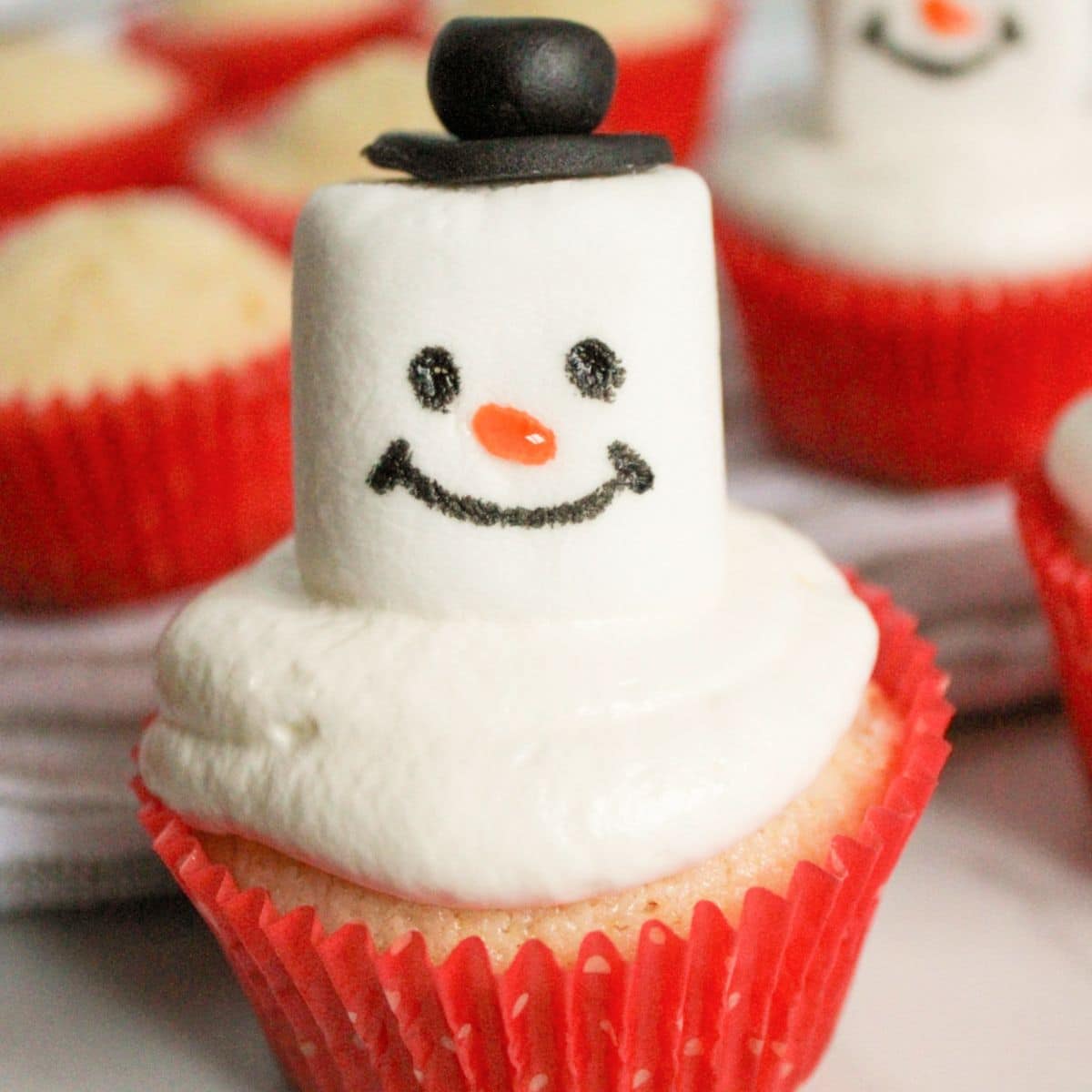 snowman cupcakes on a counter.