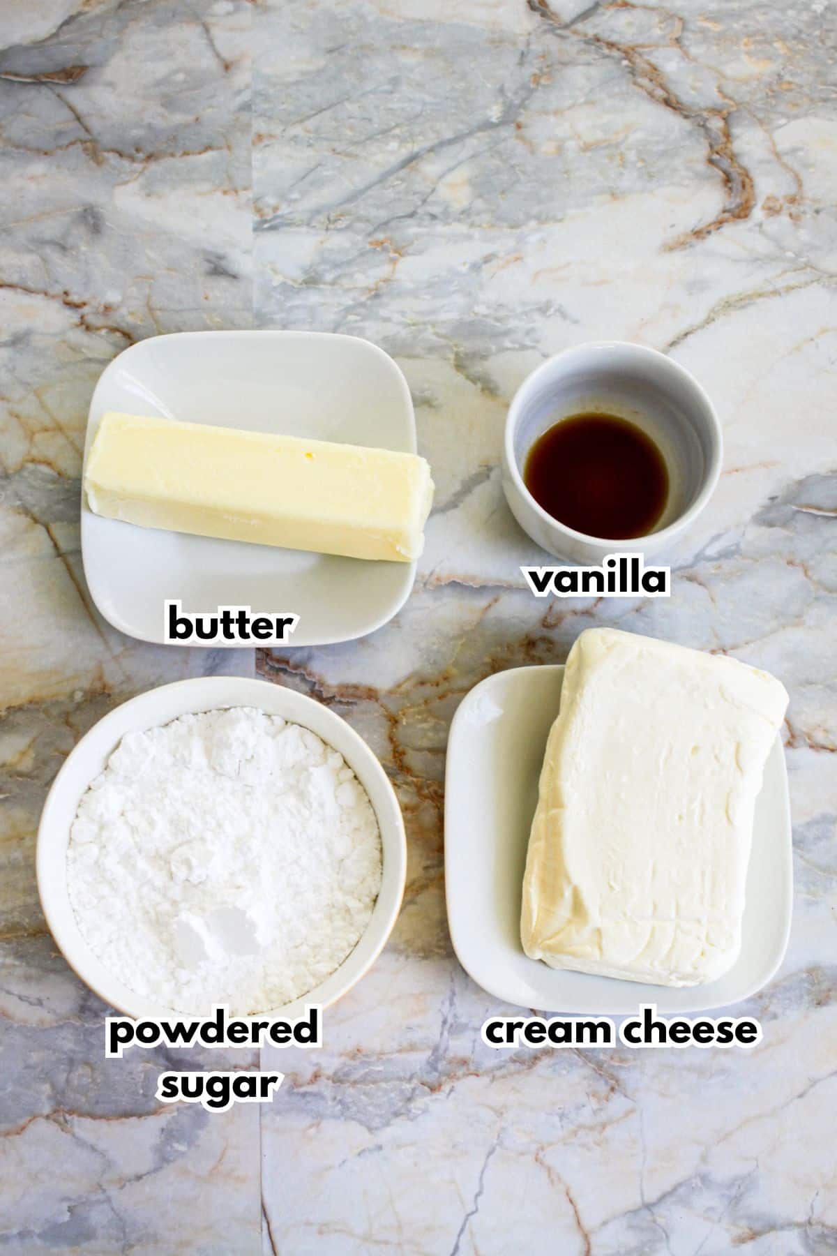 bowls of butter, vanilla, powdered sugar, and cream cheese.