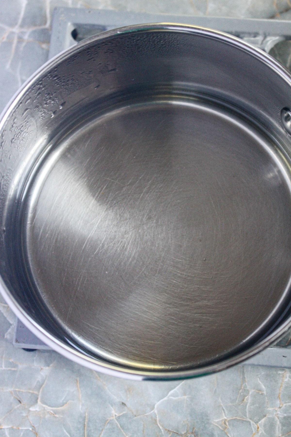 simple syrup being cooked in a saucepan.