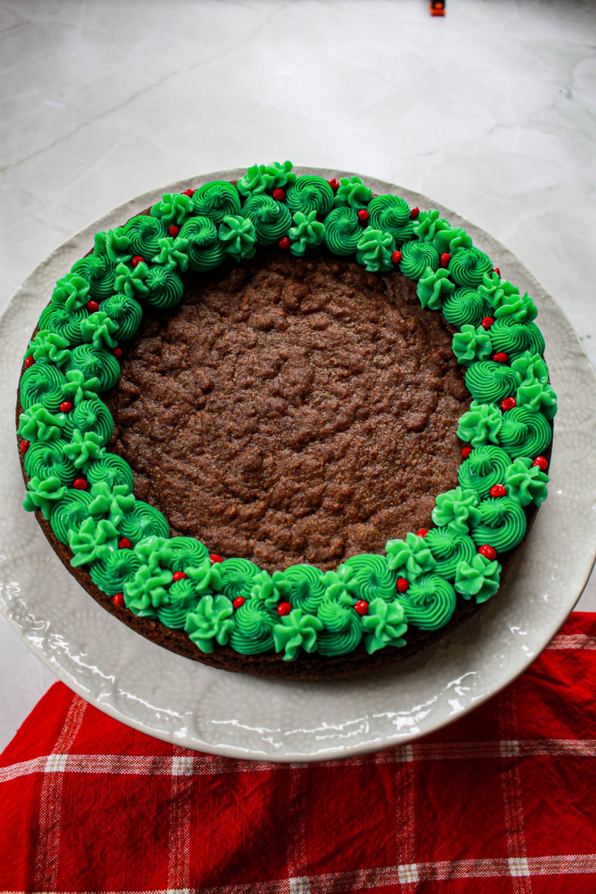 uncut decorated spiced cookie cake on a plate.