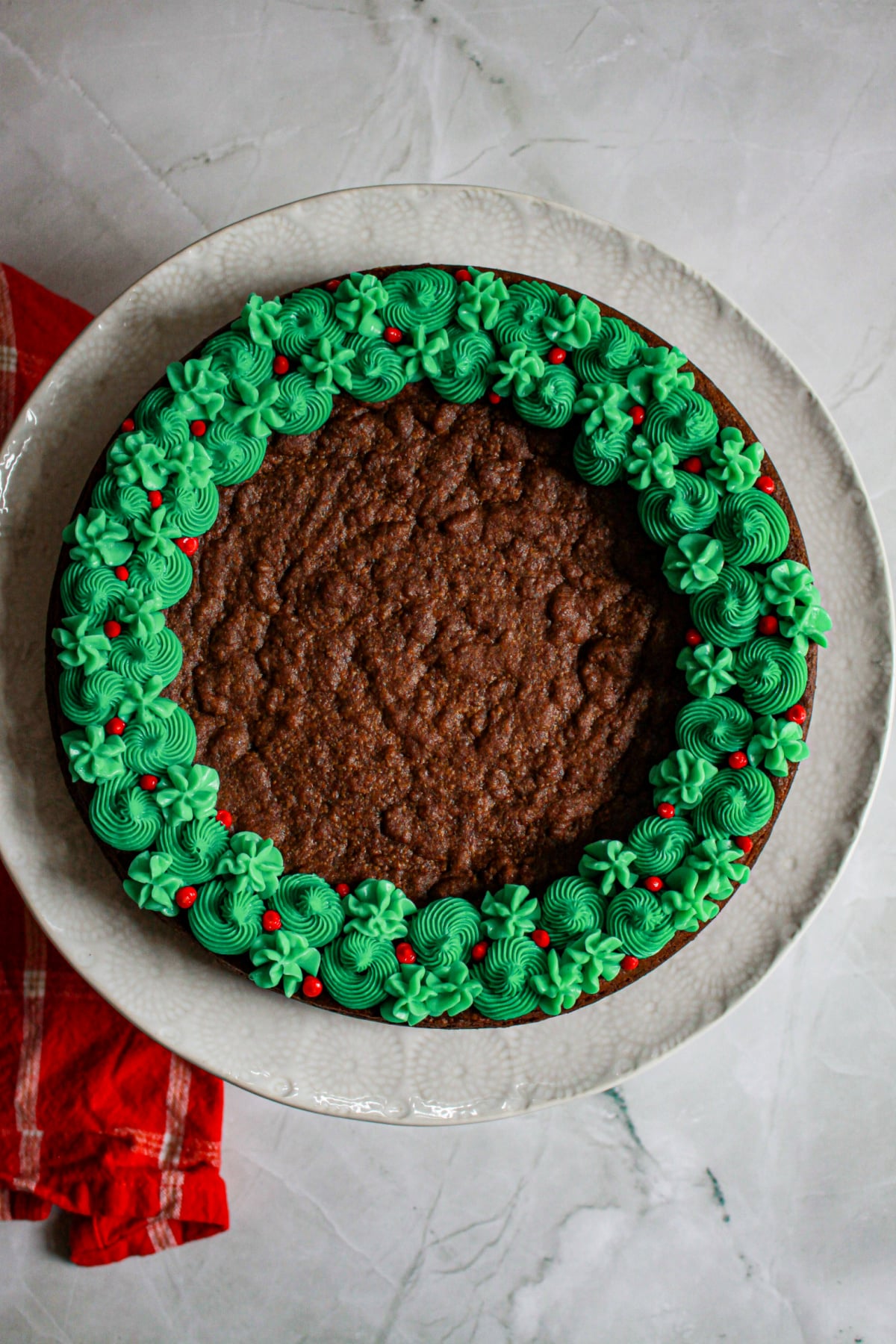 uncut decorated spiced cookie cake on a plate.