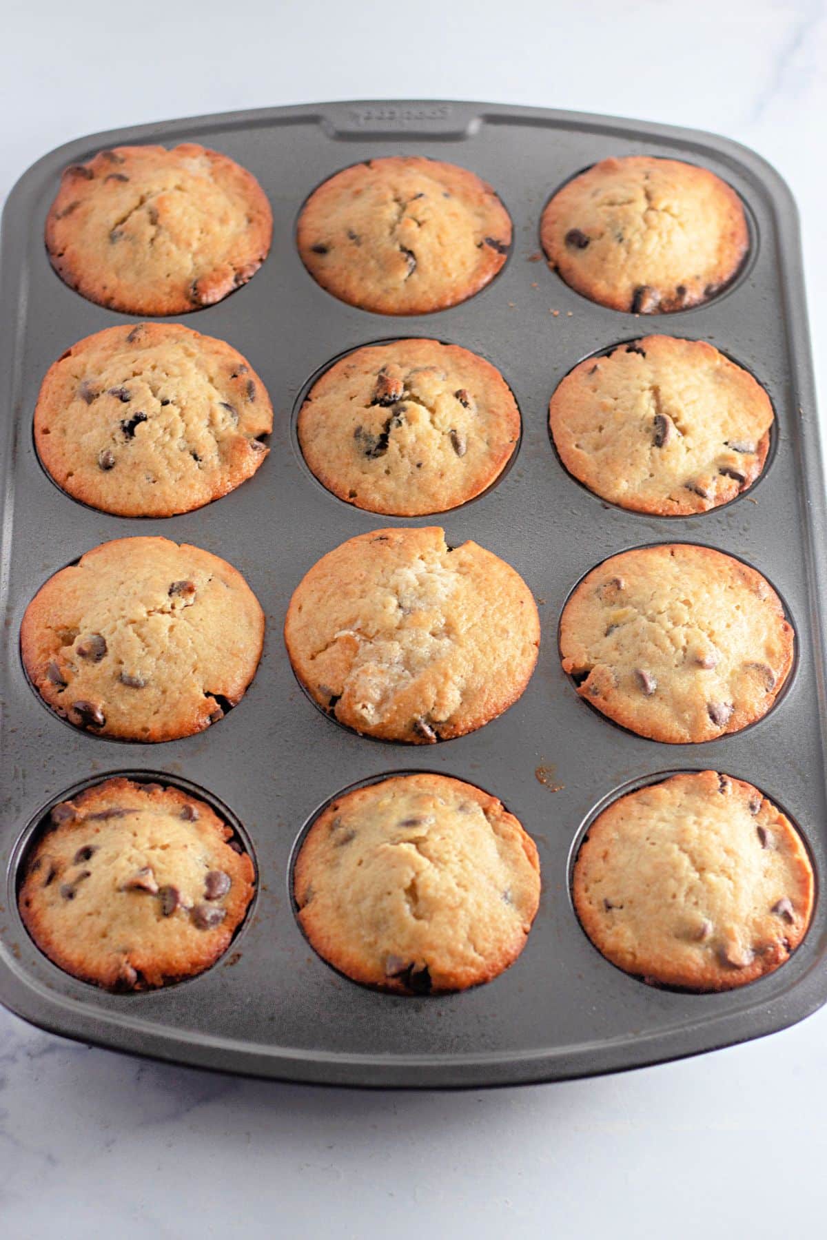 baked muffins cooling in a baking pan.