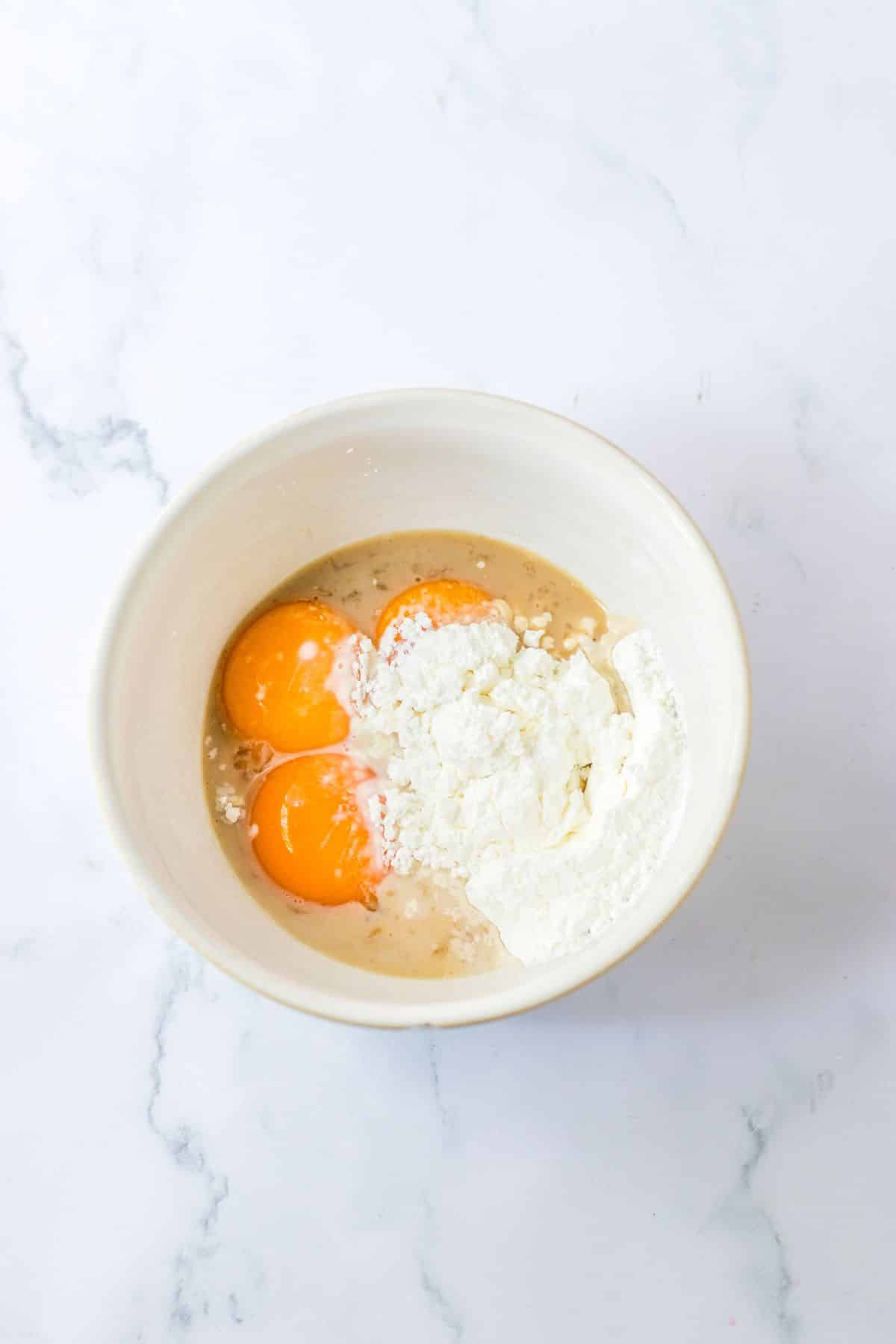 eggs and cornstarch being mixed in a small bowl.