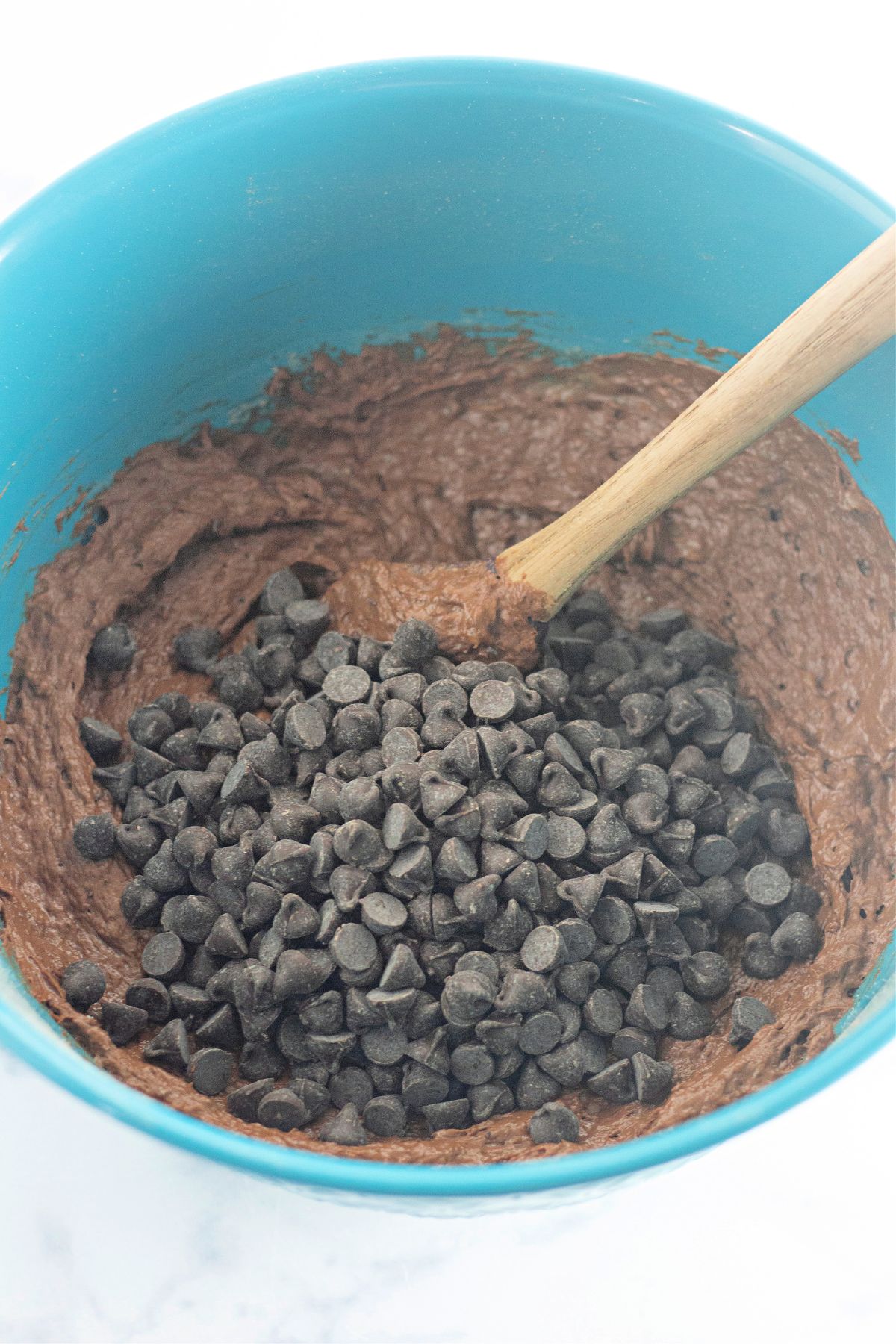 chocolate chips being folded into banana bread mixture.