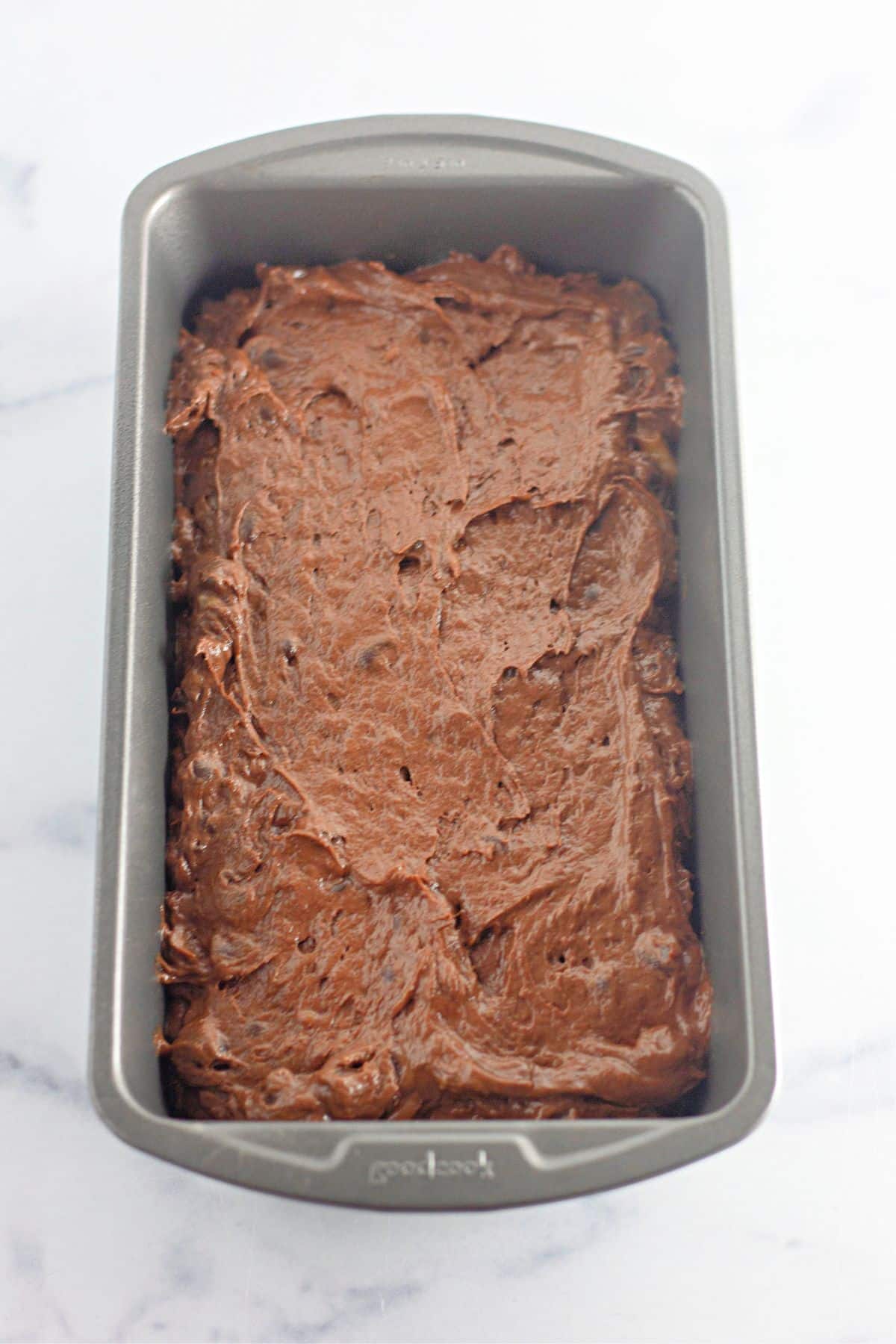chocolate banana bread batter in a loaf pan.
